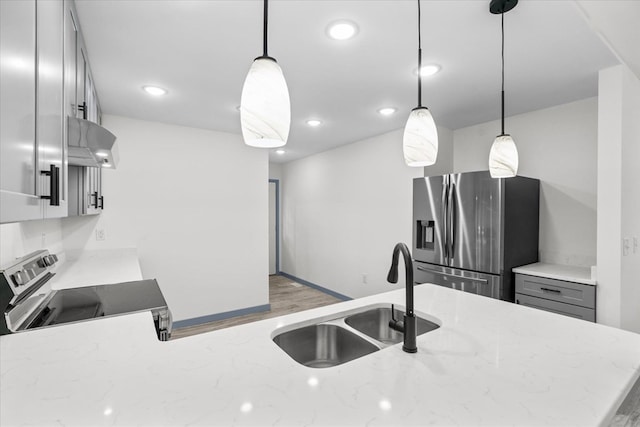 409 Van Buren Dr, Dalton, GA 30721 - kitchen with stainless steel appliances, extractor fan, light stone counters, pendant lighting, and recessed lighting