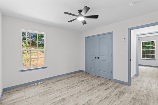 409 Van Buren Dr, Dalton, GA 30721 - unfurnished bedroom with light wood finished floors, a closet, and a ceiling fan