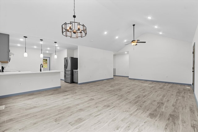409 Van Buren Dr, Dalton, GA 30721 - unfurnished living room with recessed lighting, light wood-style floors, vaulted ceiling, a chandelier, and a ceiling fan