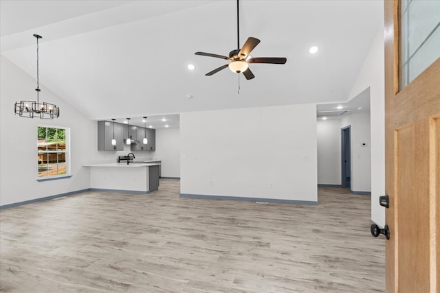 409 Van Buren Dr, Dalton, GA 30721 - unfurnished living room featuring high vaulted ceiling, light wood-style flooring, ceiling fan, a chandelier, and recessed lighting