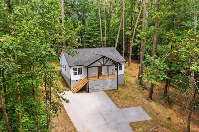 409 Van Buren Dr, Dalton, GA 30721 - view of front of home with a shingled roof, concrete driveway, stairs, and a wooded view