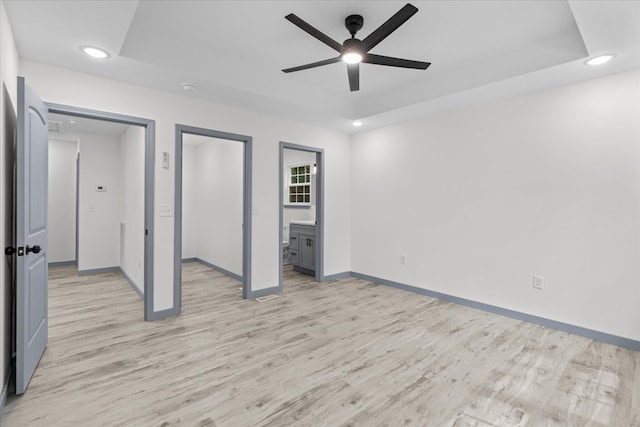409 Van Buren Dr, Dalton, GA 30721 - unfurnished bedroom featuring light wood-style flooring, recessed lighting, a tray ceiling, and ensuite bathroom