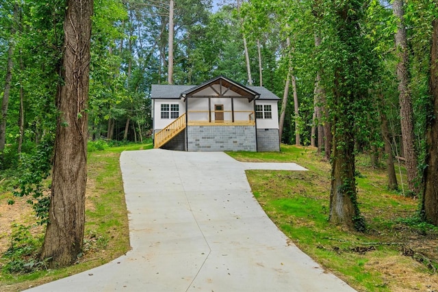 409 Van Buren Dr, Dalton, GA 30721 - view of front of house with concrete driveway, stairway, a front yard, and brick siding