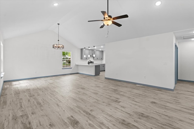 409 Van Buren Dr, Dalton, GA 30721 - unfurnished living room featuring lofted ceiling, light wood-style floors, ceiling fan, a chandelier, and recessed lighting