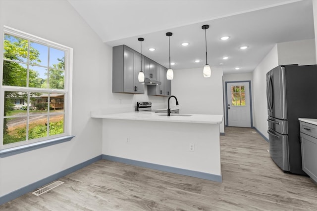 409 Van Buren Dr, Dalton, GA 30721 - kitchen with stainless steel appliances, under cabinet range hood, light countertops, gray cabinetry, and recessed lighting