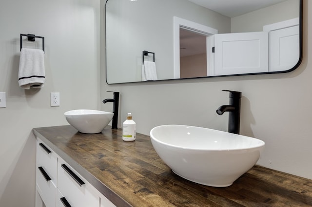 bathroom with vanity and wood finished floors