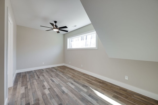 unfurnished room with baseboards, a ceiling fan, visible vents, and light wood-style floors