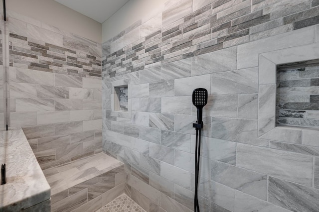 bathroom with a tile shower