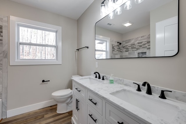 bathroom with vanity, a shower, hardwood / wood-style floors, and toilet