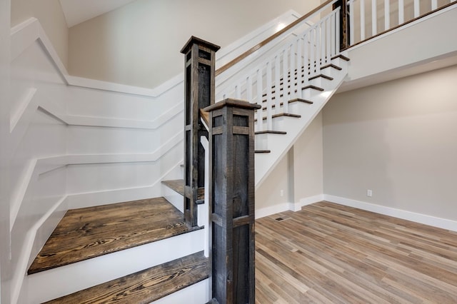 staircase with wood-type flooring