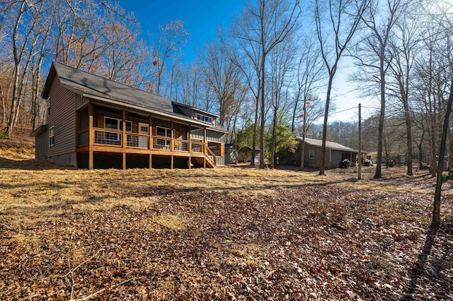 back of property featuring a wooden deck