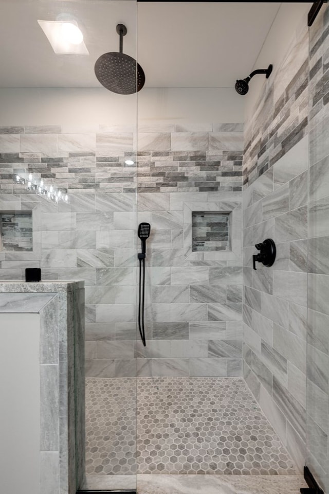 bathroom with a tile shower