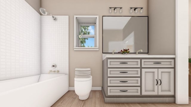 full bathroom featuring vanity, tiled shower / bath, hardwood / wood-style floors, and toilet