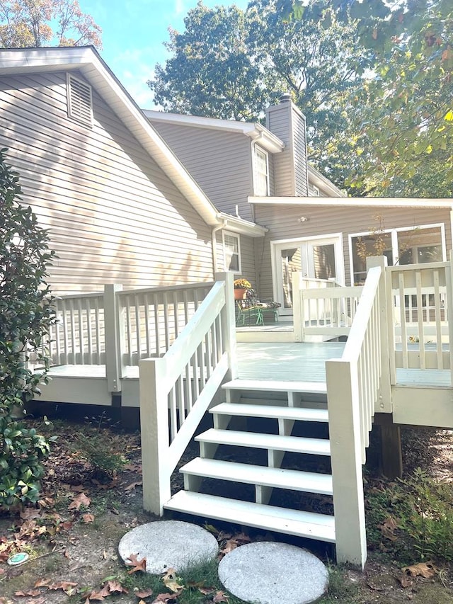 back of house with a wooden deck