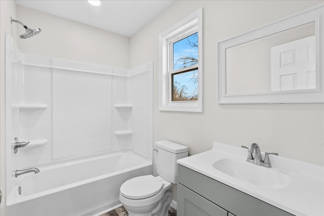 bathroom with toilet, vanity, and bathing tub / shower combination