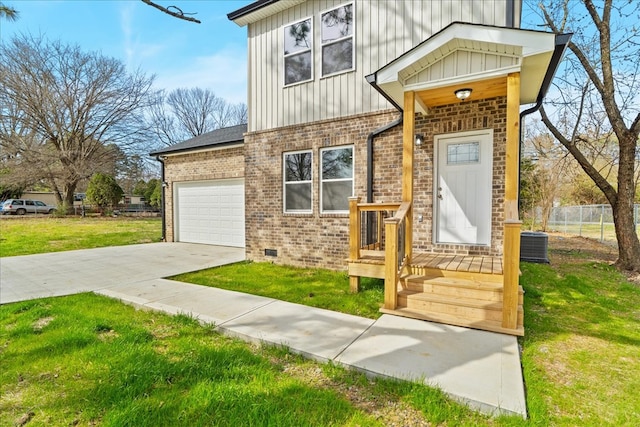 view of front of property with a front yard, an attached garage, concrete driveway, board and batten siding, and brick siding