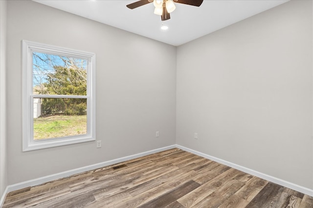 unfurnished room featuring visible vents, baseboards, a ceiling fan, and wood finished floors