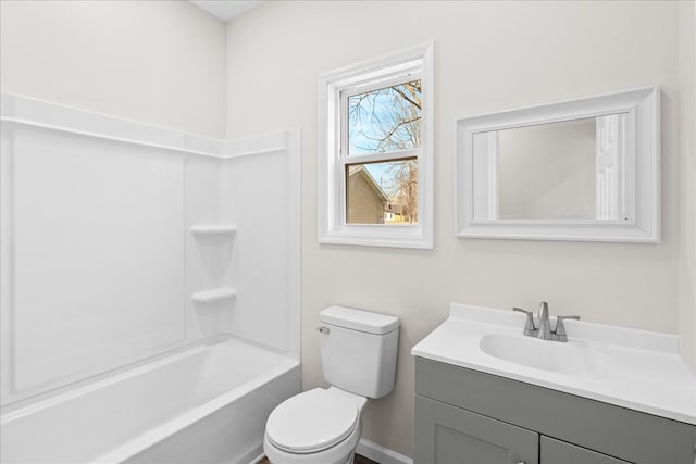 bathroom featuring toilet, vanity, and baseboards