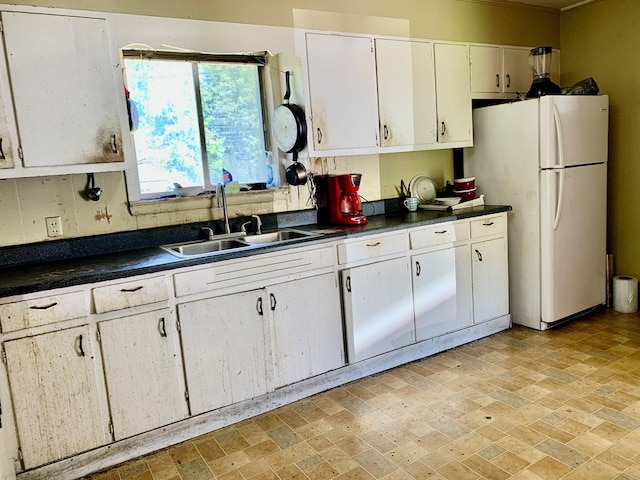 3281 Dug Gap Rd, Dalton, GA 30720 - kitchen featuring freestanding refrigerator, a sink, dark countertops, and white cabinets
