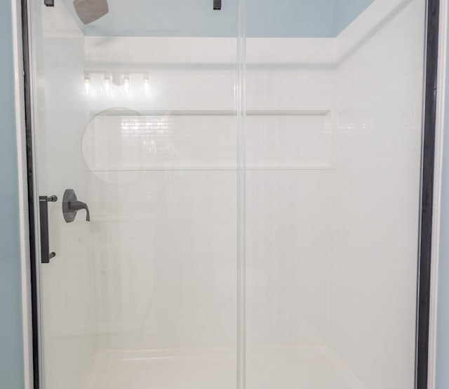 bathroom with a shower with shower door