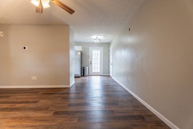 foyer featuring ceiling fan, dark hardwood / wood-style floors, and a textured ceiling