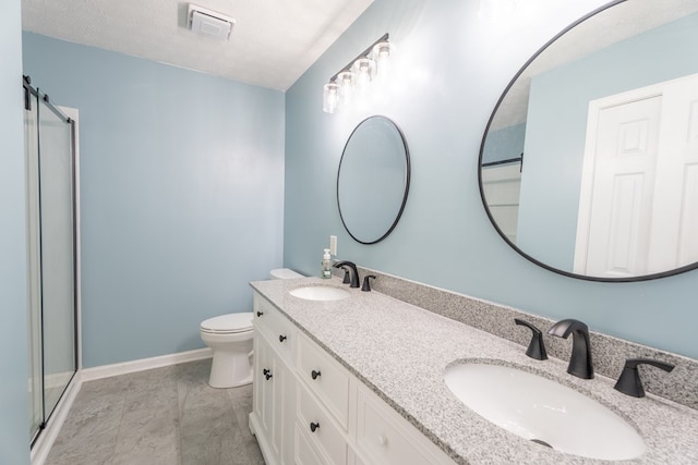 bathroom featuring vanity, walk in shower, a textured ceiling, and toilet