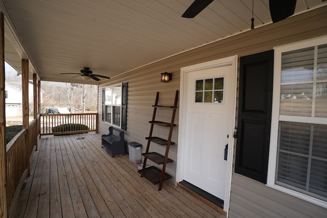 deck with ceiling fan and covered porch