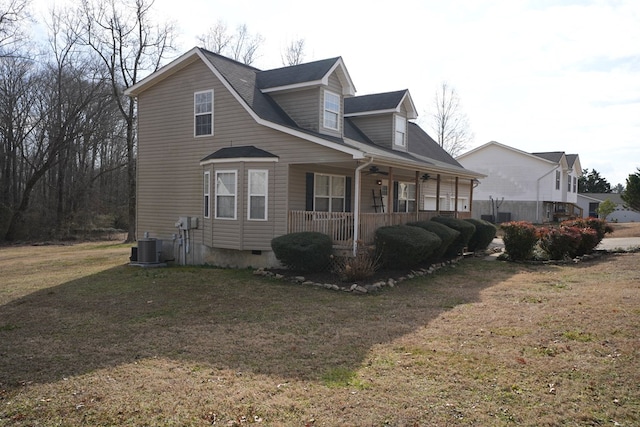 view of property exterior featuring a yard, central AC, and covered porch