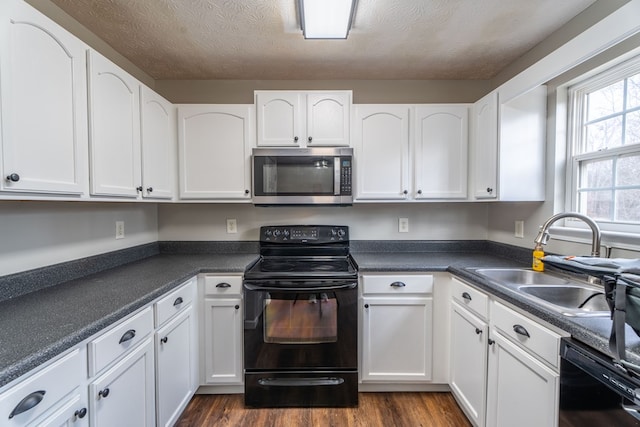 kitchen featuring white cabinets, sink, and black appliances