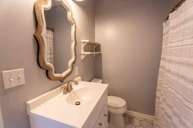 bathroom featuring vanity, toilet, and tile patterned flooring