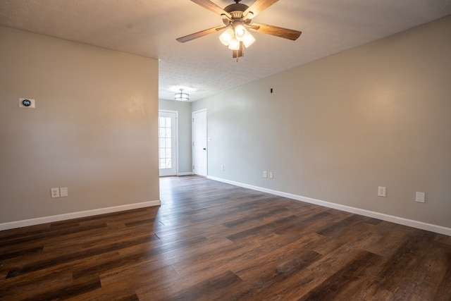 empty room featuring dark hardwood / wood-style floors, a textured ceiling, and ceiling fan