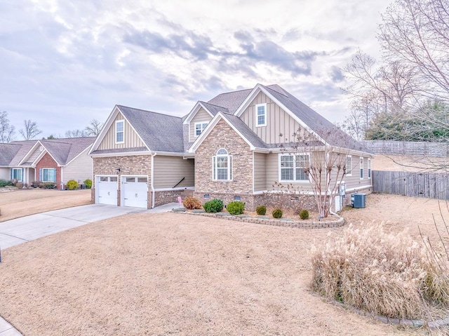 craftsman inspired home with a garage and central air condition unit