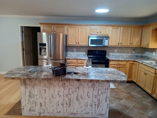 kitchen with stone countertops, decorative backsplash, ornamental molding, a center island, and stainless steel appliances