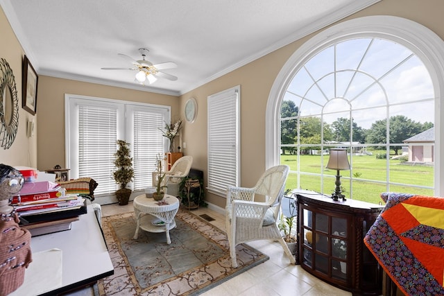 living room with ornamental molding, ceiling fan, and a textured ceiling