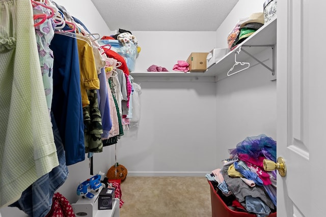 walk in closet featuring light carpet