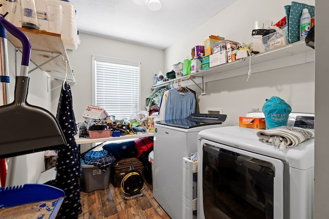 laundry room featuring independent washer and dryer, dark hardwood / wood-style flooring, and a textured ceiling