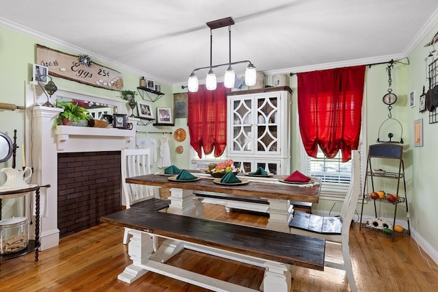 dining space with hardwood / wood-style flooring and ornamental molding