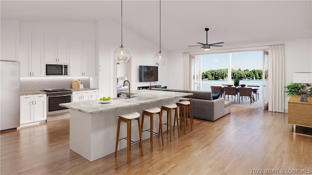 kitchen with backsplash, hanging light fixtures, light stone countertops, appliances with stainless steel finishes, and white cabinetry