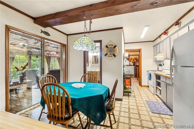 dining area featuring crown molding and beam ceiling