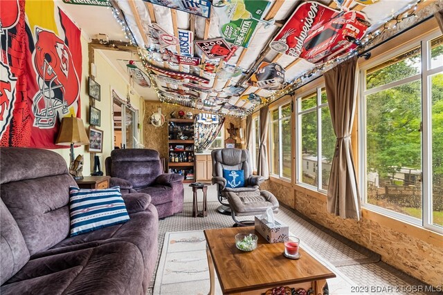 living room featuring lofted ceiling