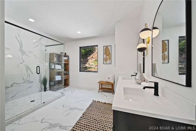 bathroom with dual vanity, a shower with shower door, and tile patterned flooring