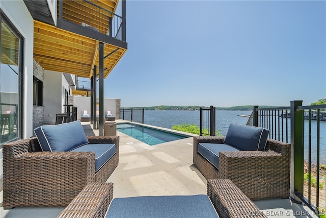 view of swimming pool featuring a water view and a patio area