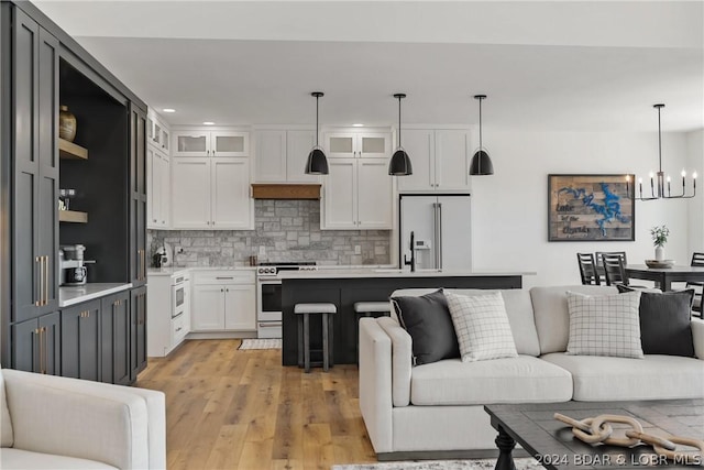 128 Palisades Yacht Club Dr, Lake Ozark, MO 65049 - kitchen featuring white cabinets, stainless steel electric range, decorative backsplash, pendant lighting, and high end fridge