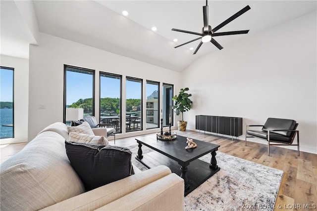 living room featuring high vaulted ceiling, ceiling fan, and light hardwood / wood-style flooring