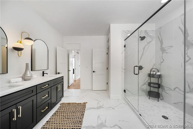 bathroom featuring a shower with door and vanity