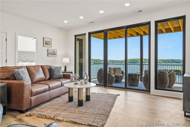 living room with wood-type flooring and a water view