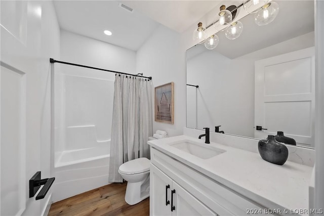 full bathroom with shower / bathtub combination with curtain, hardwood / wood-style floors, vanity, and toilet