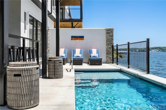 view of pool with a water view