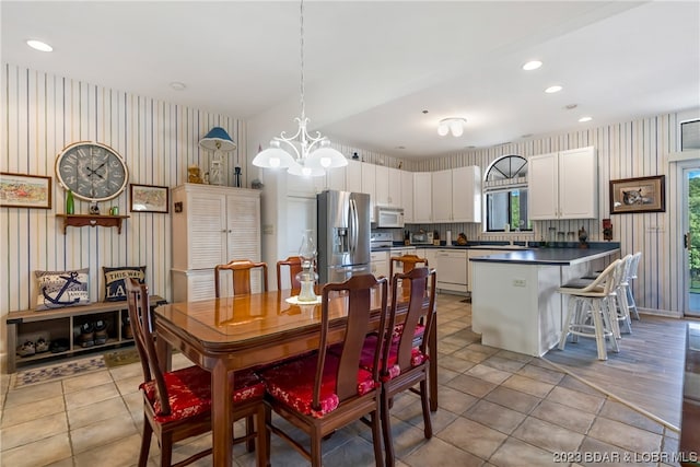 tiled dining area featuring a notable chandelier