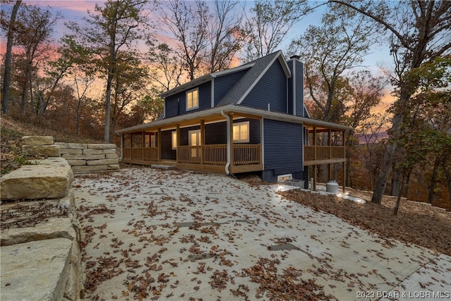 property exterior at dusk with a porch